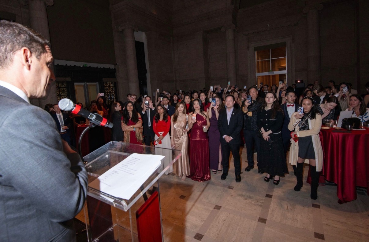 Speaker addressing members at a Women in AI gala
